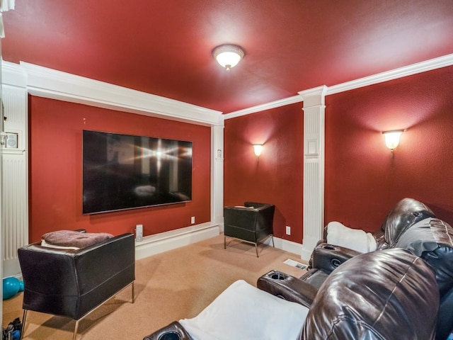 carpeted cinema room with crown molding and baseboards