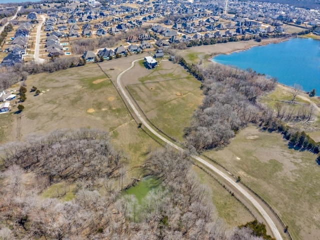 birds eye view of property with a residential view and a water view