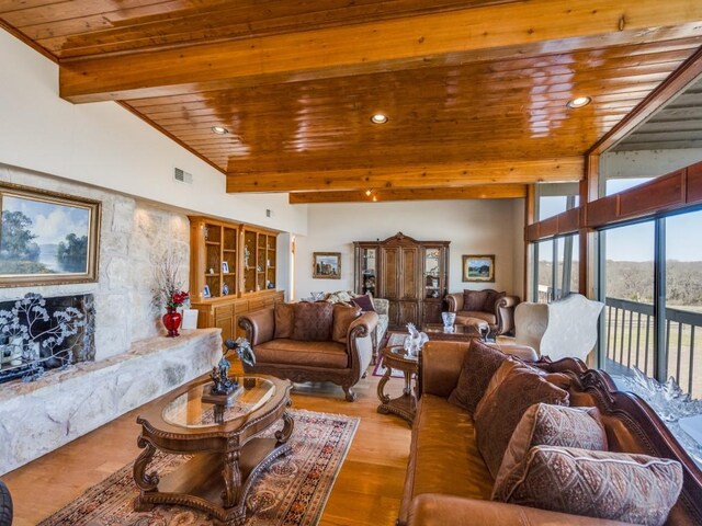 living area featuring visible vents, beamed ceiling, wood ceiling, recessed lighting, and wood finished floors