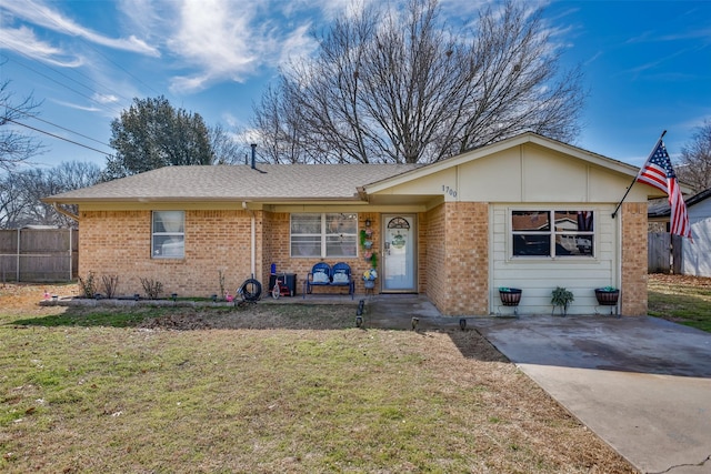 single story home with brick siding, a front yard, and fence