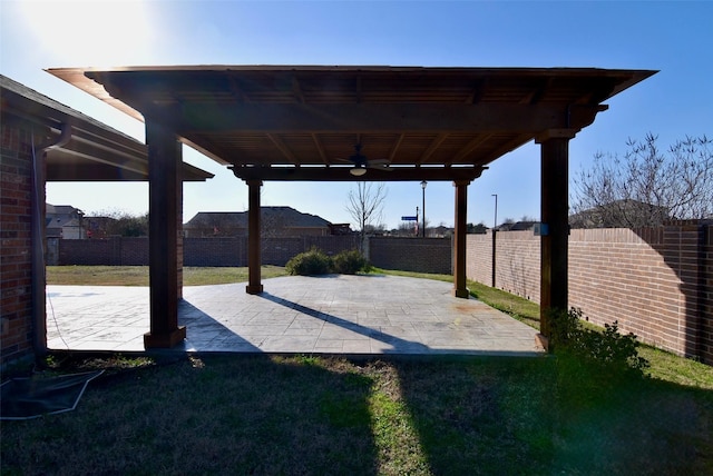 view of patio with a fenced backyard, ceiling fan, and a pergola