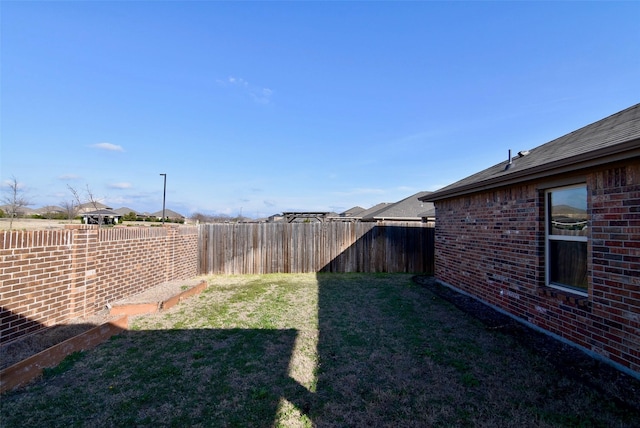 view of yard featuring a fenced backyard