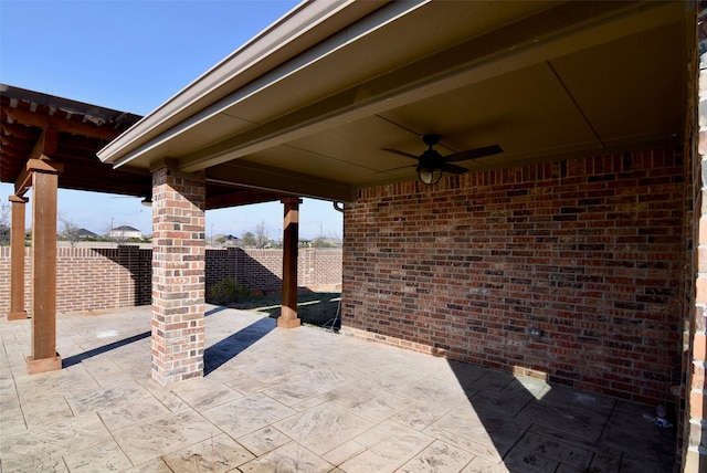 view of patio with a fenced backyard and a ceiling fan