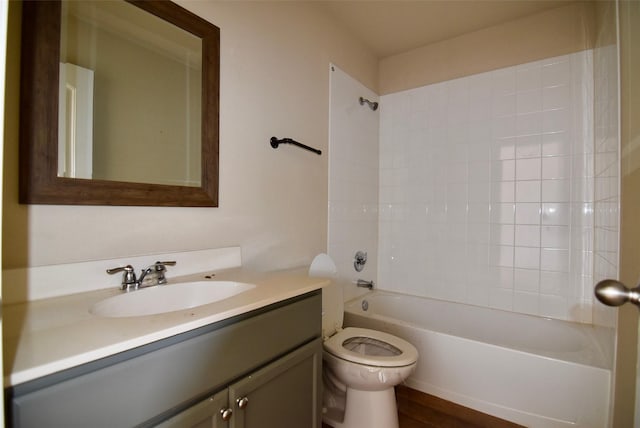 bathroom featuring toilet, bathing tub / shower combination, and vanity