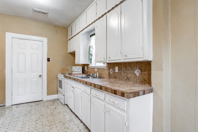 kitchen featuring white electric stove, a sink, visible vents, white cabinets, and light floors