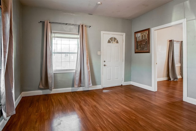 entryway with wood finished floors and baseboards