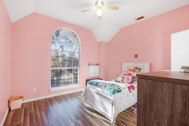 bedroom featuring visible vents, wood finished floors, and vaulted ceiling