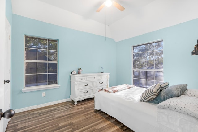 bedroom featuring dark wood finished floors, vaulted ceiling, a ceiling fan, and baseboards