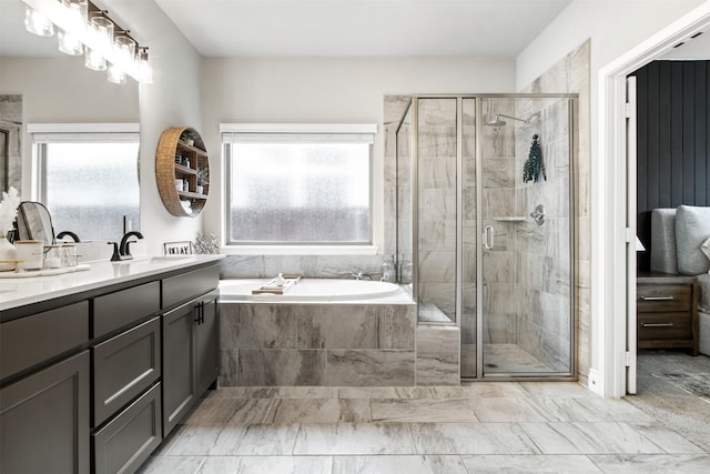 full bath with double vanity, a garden tub, a shower stall, and marble finish floor