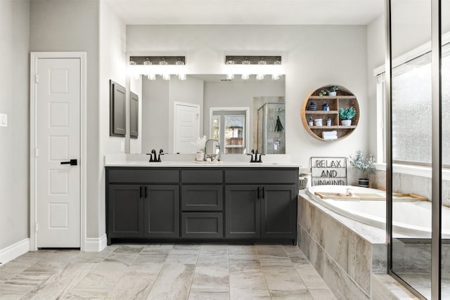 bathroom with double vanity, a closet, a sink, and a bath