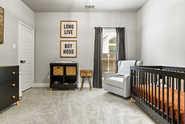 carpeted bedroom featuring a nursery area, visible vents, and baseboards