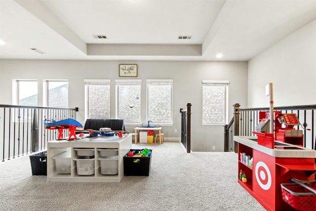 recreation room featuring recessed lighting, visible vents, a tray ceiling, and carpet flooring