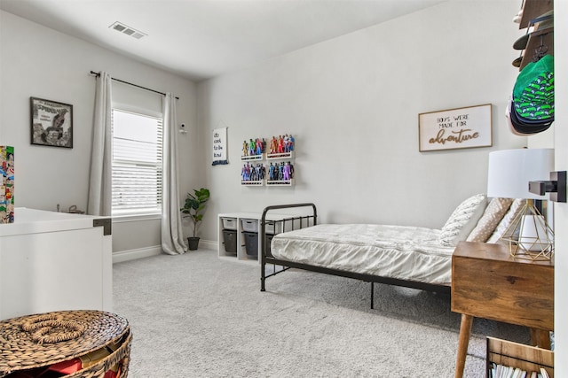 carpeted bedroom featuring baseboards and visible vents