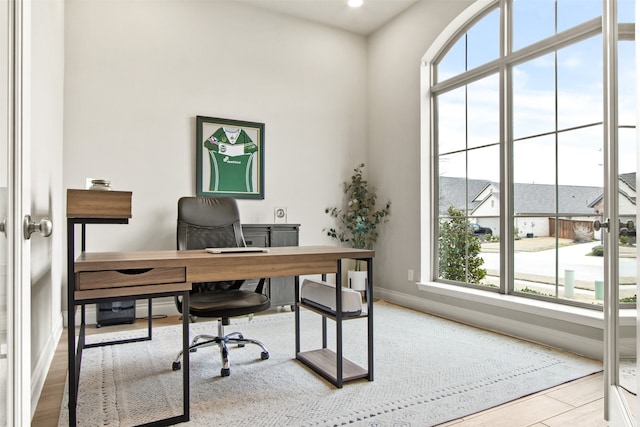 office area with light wood-type flooring and baseboards