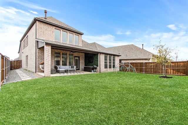 back of property featuring a patio, a fenced backyard, brick siding, an outdoor living space, and a yard