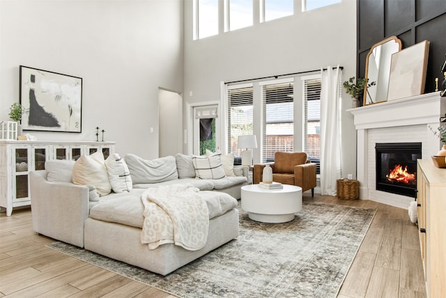 living area with a fireplace and wood finished floors