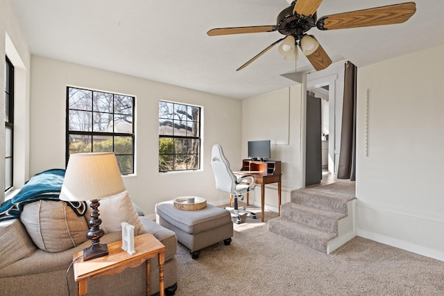 sitting room featuring carpet flooring, a ceiling fan, and baseboards