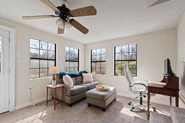 office featuring carpet floors, ceiling fan, and baseboards