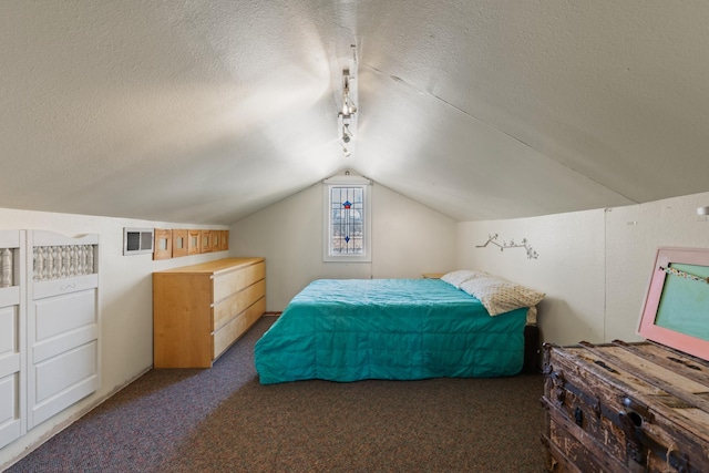 carpeted bedroom with lofted ceiling, visible vents, a textured ceiling, and track lighting