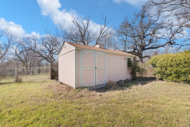 view of shed featuring fence