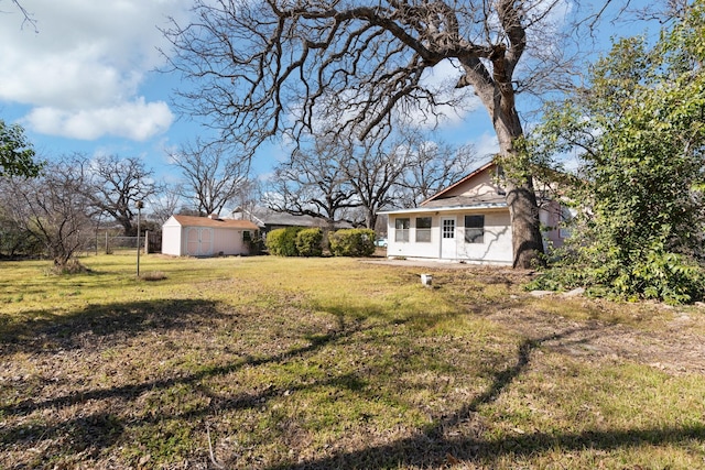 view of yard featuring an outbuilding and a sunroom