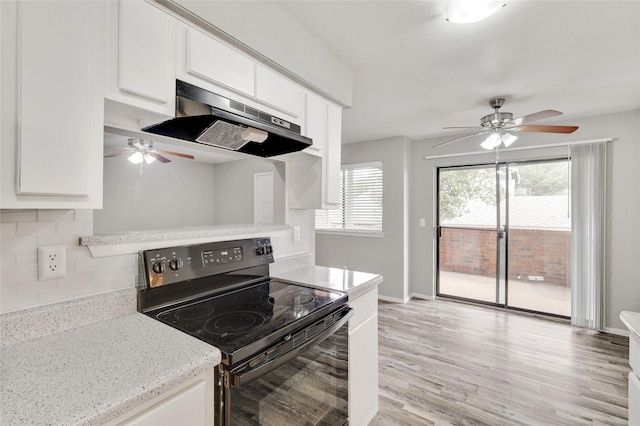 kitchen featuring electric range, backsplash, white cabinetry, and under cabinet range hood