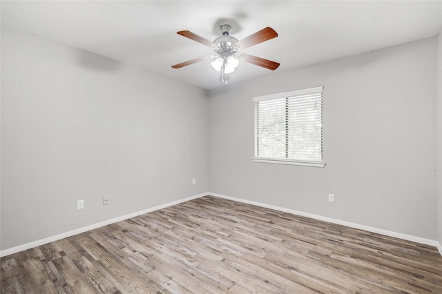 unfurnished room featuring ceiling fan, light wood finished floors, and baseboards