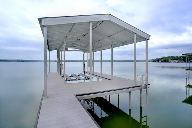 dock area with a water view and boat lift