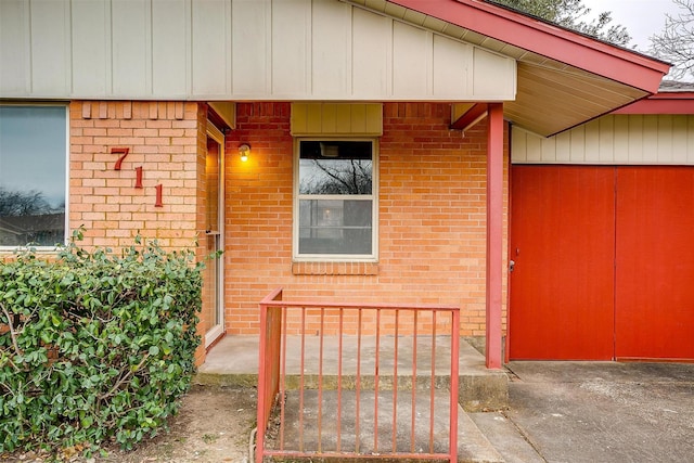 view of exterior entry with brick siding