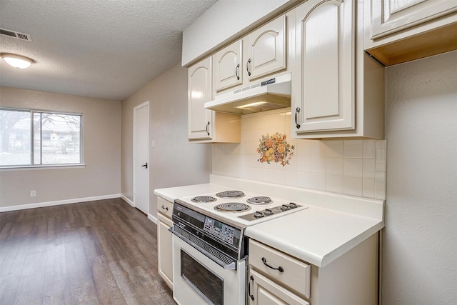 kitchen featuring under cabinet range hood, visible vents, light countertops, and electric stove