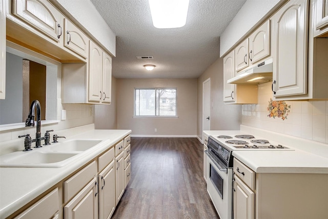 kitchen with dark wood finished floors, white electric stove, light countertops, a sink, and under cabinet range hood