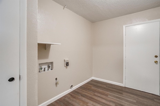 washroom featuring dark wood finished floors, hookup for a washing machine, a textured ceiling, laundry area, and baseboards