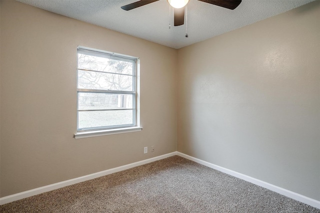 carpeted empty room featuring a ceiling fan, baseboards, and a textured ceiling