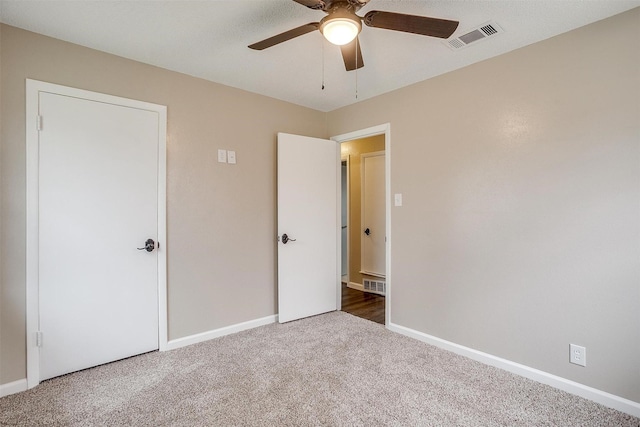 unfurnished bedroom featuring carpet floors, visible vents, and baseboards