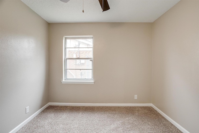 unfurnished room with a textured ceiling, ceiling fan, carpet, and baseboards