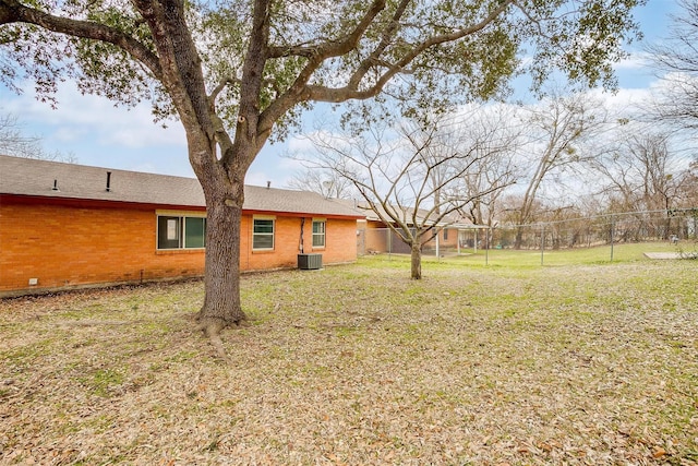 view of yard featuring cooling unit and fence