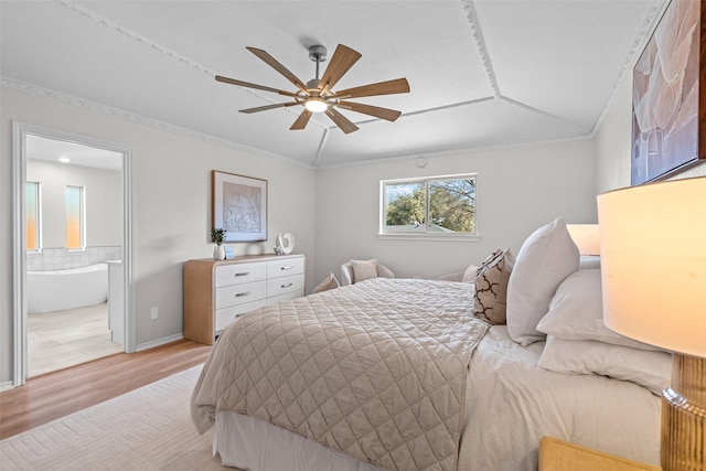 bedroom with baseboards, connected bathroom, a ceiling fan, crown molding, and light wood-style floors