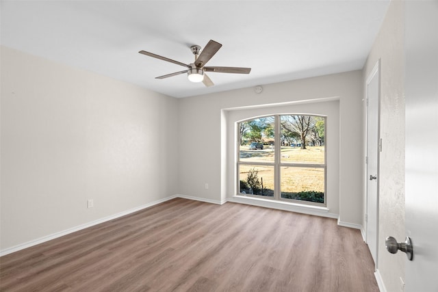 empty room with light wood-style flooring, baseboards, and ceiling fan