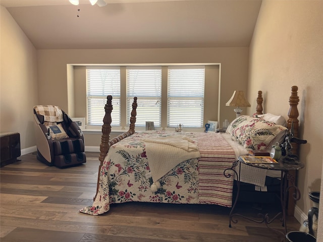 bedroom with lofted ceiling, ceiling fan, baseboards, and dark wood finished floors