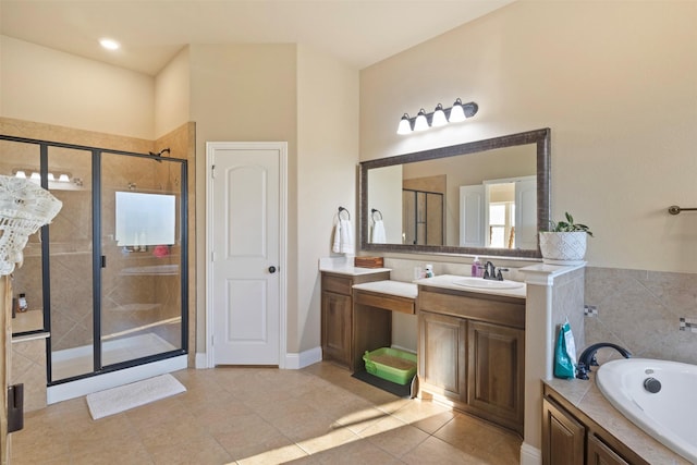 bathroom with a stall shower, tile patterned floors, a garden tub, and vanity