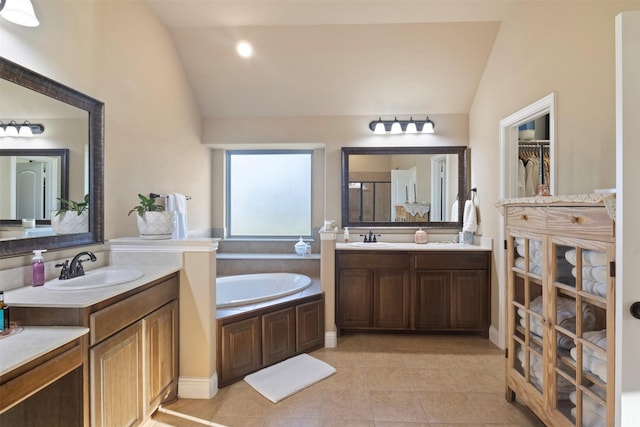 full bathroom featuring lofted ceiling, a sink, and a garden tub