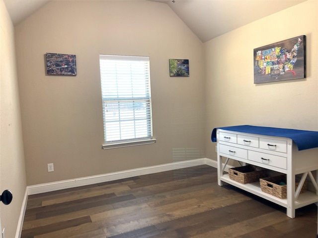 bedroom featuring dark wood-type flooring, vaulted ceiling, and baseboards