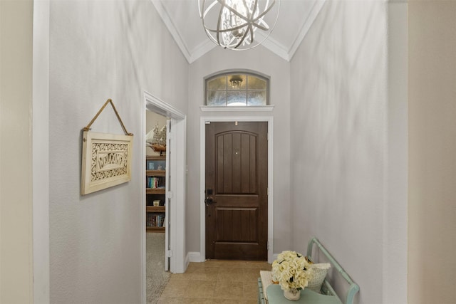 entrance foyer with light tile patterned floors, baseboards, vaulted ceiling, crown molding, and a chandelier