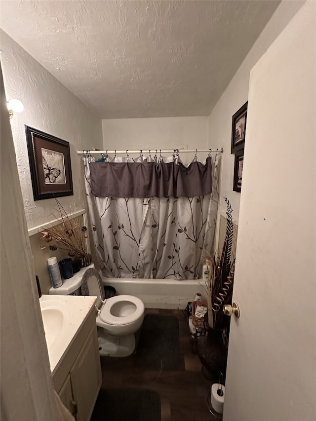 5813 Hiett Ct, Fort Worth, TX 76112 - bathroom featuring a textured ceiling, shower / bath combo with shower curtain, vanity, wood finished floors, and a textured wall