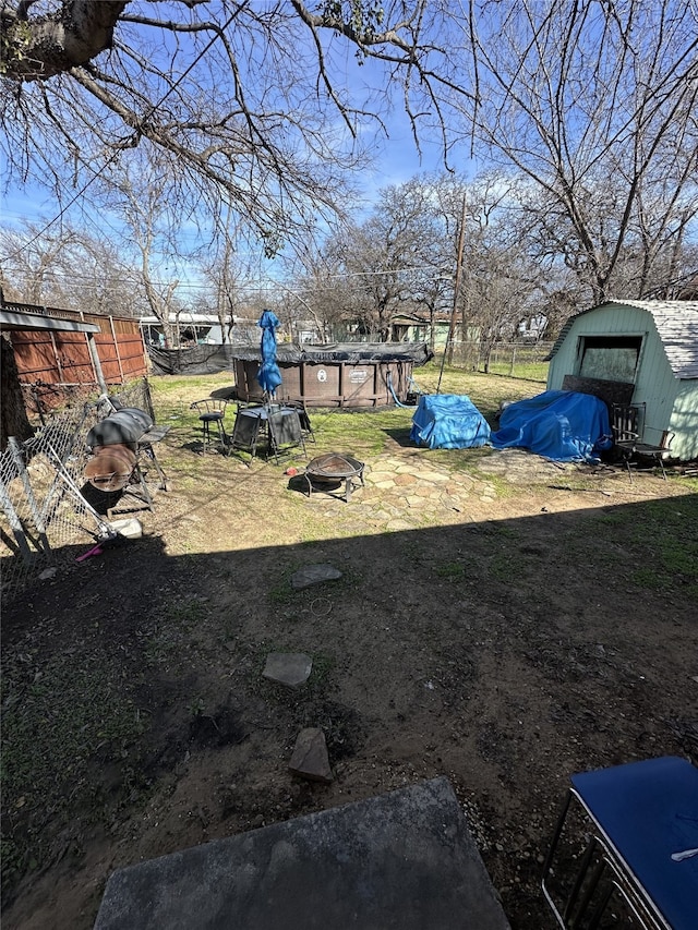 view of yard featuring an outdoor pool and fence