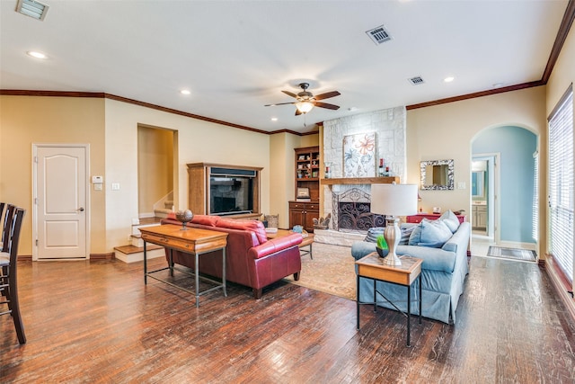 living area with dark wood-style floors, a fireplace, stairs, and visible vents