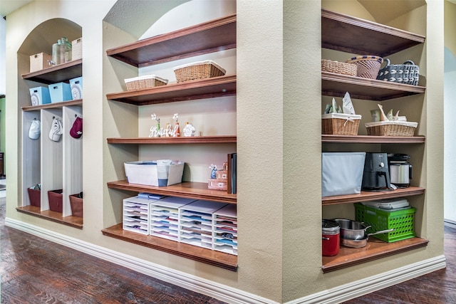 details featuring a textured wall, wood finished floors, and baseboards