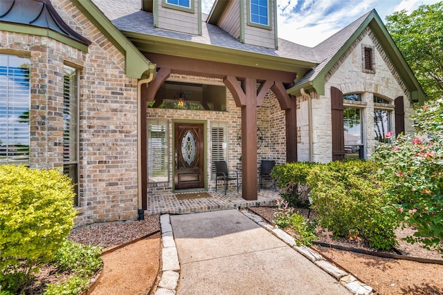 entrance to property with brick siding and roof with shingles