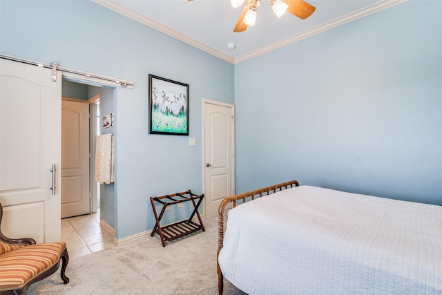 bedroom featuring light tile patterned floors, ceiling fan, a barn door, light colored carpet, and crown molding