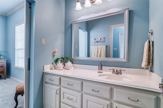 bathroom featuring ornamental molding, vanity, and baseboards